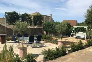 An early photo shows the view from the house with yews in steel planters, and our Sitting Spiritually Swing Seat