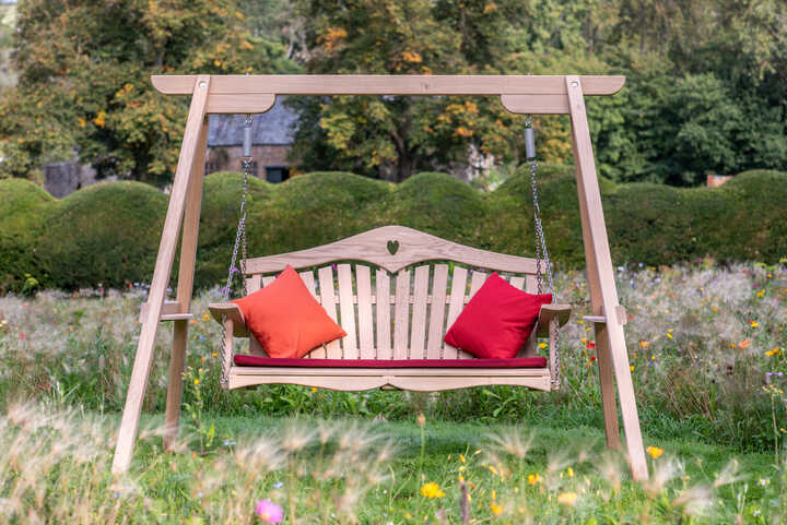 Swing seat with red cushions
