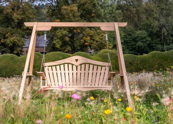 Wooden swing seat set in garden